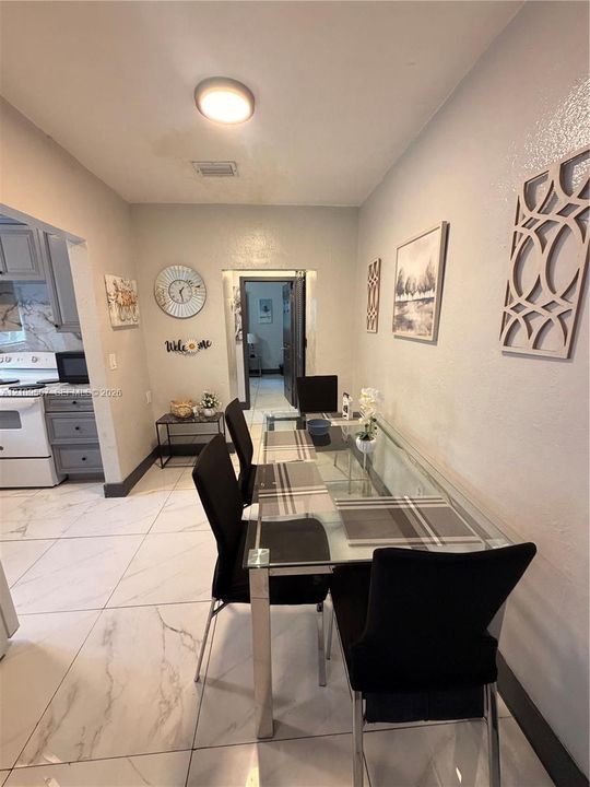 Large format tile flooring, flush-mount ceiling light fixture, and recessed door frames