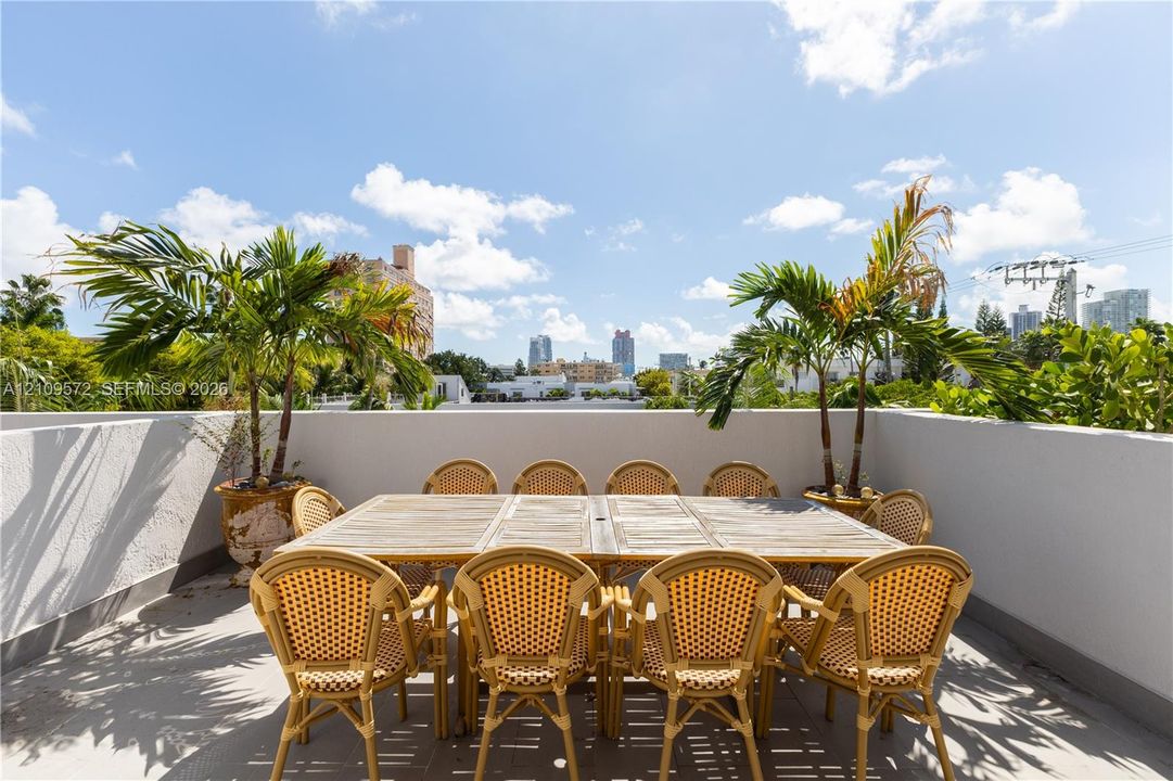 Rooftop terrace featuring solid masonry walls and concrete-finish flooring