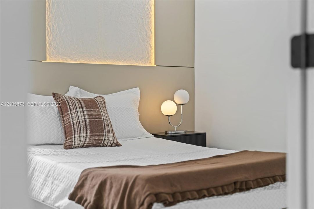 Custom built-in headboard featuring a textured inset panel and integrated accent lighting