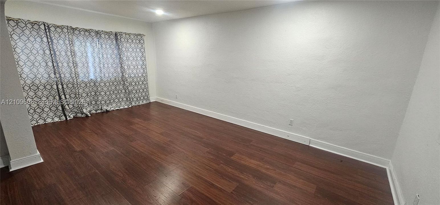 Interior space featuring wood-finish flooring, recessed ceiling lighting, and neutral-toned wall finishes
