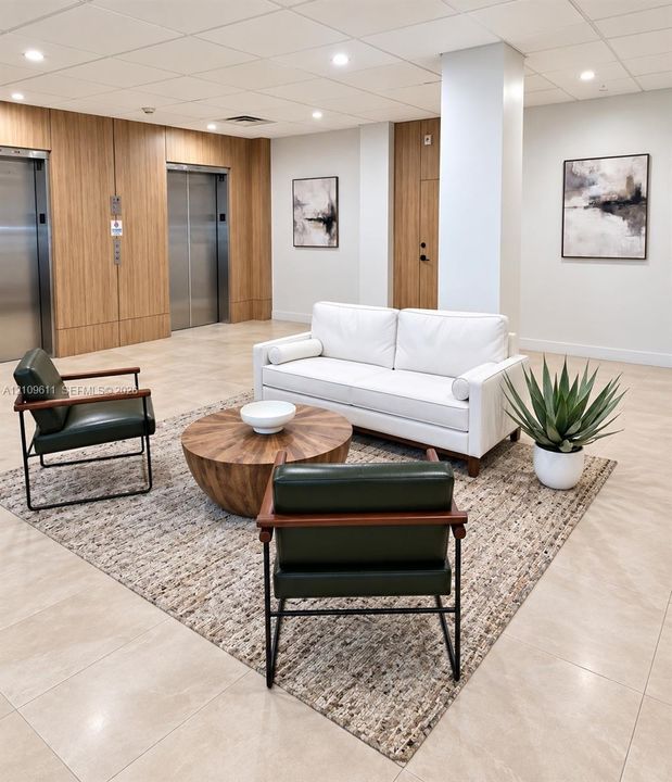 Lobby area featuring dual stainless steel elevators, wood-finish paneling, tile flooring, and recessed ceiling lighting
