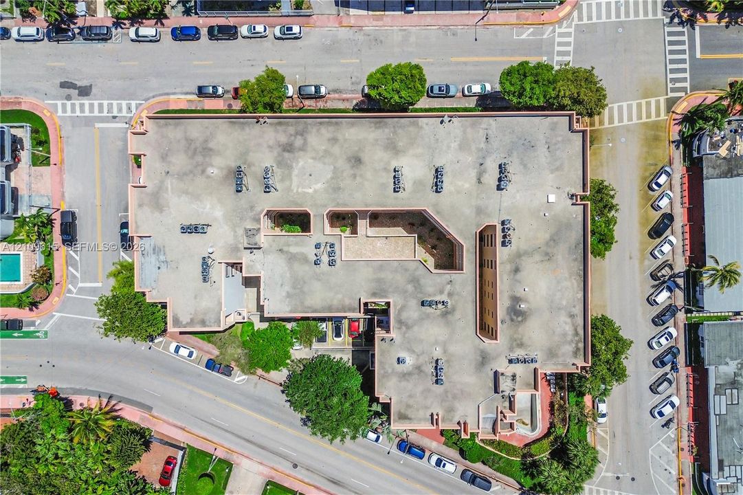 Aerial view of the building exterior featuring multiple HVAC units on the roof and integrated internal courtyards