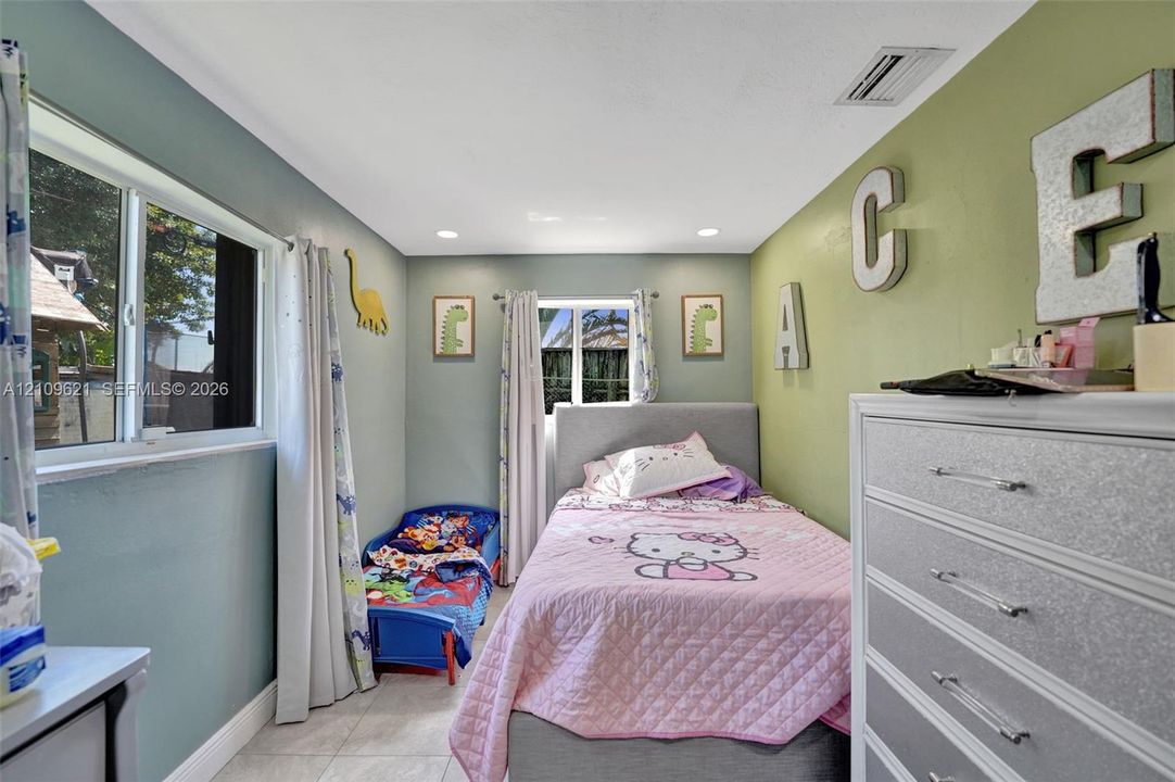 Neutral-toned tiled flooring, recessed ceiling lighting, and dual-pane windows