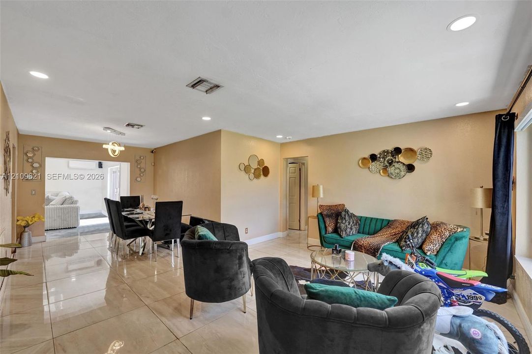 Large-format tile flooring, recessed ceiling lighting, and neutral wall tones