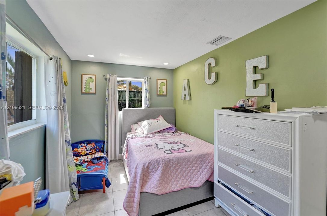 Room featuring dual-pane windows, recessed lighting, and tile flooring