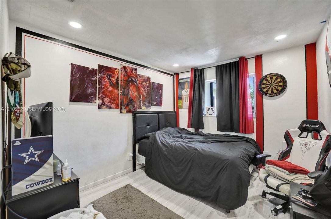 Room featuring recessed ceiling lighting and wood-finish flooring