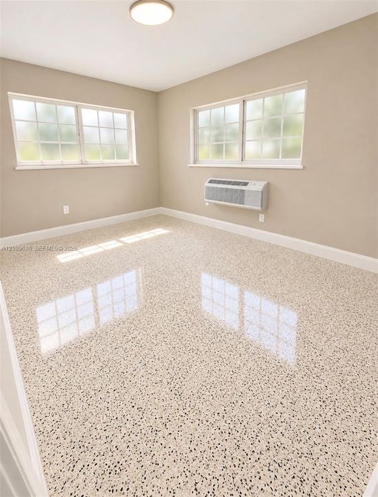 Polished terrazzo flooring, dual-pane grid windows, neutral wall paint, and wall-mounted climate control unit