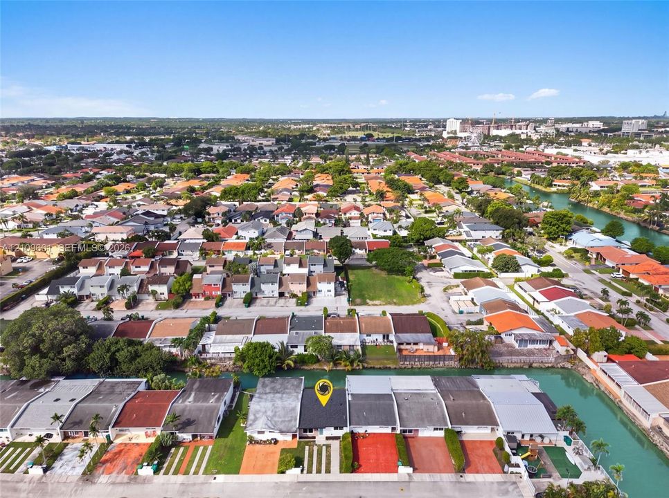 Aerial view of residential property featuring a dedicated driveway and water frontage