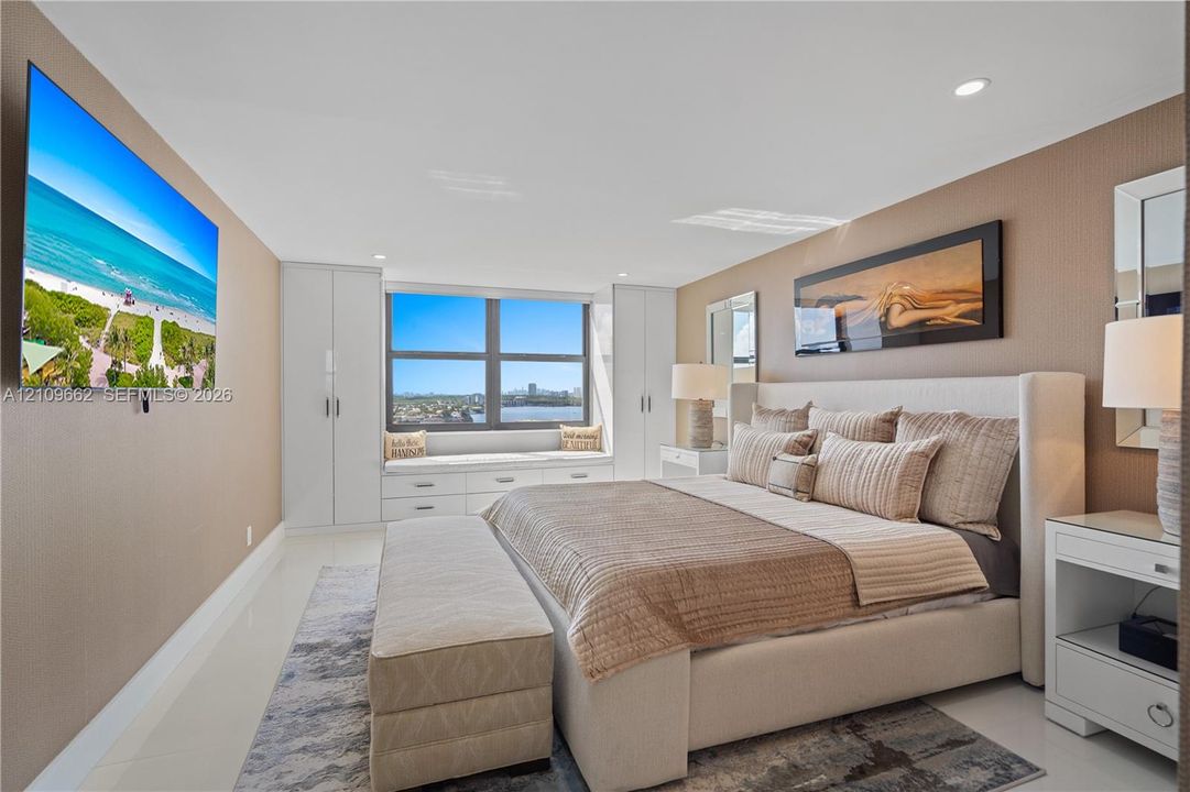 Built-in floor-to-ceiling cabinetry, recessed lighting, and a custom window seat featuring integrated drawers