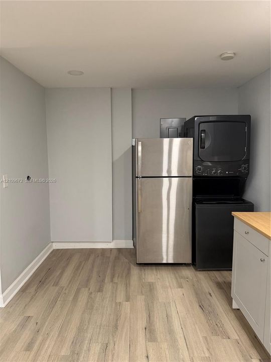 Interior space featuring wood-finish flooring, recessed lighting, neutral-toned walls, and a single-pane window