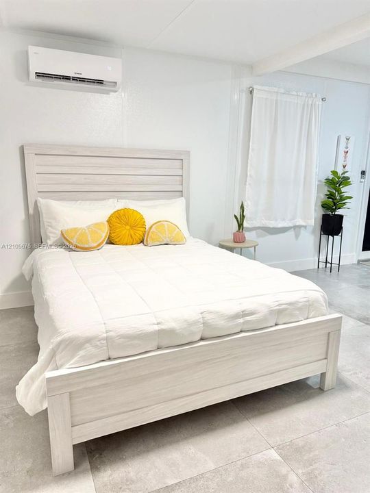 Wall-mounted ductless climate control system, large-format tile flooring, and neutral wall finishes