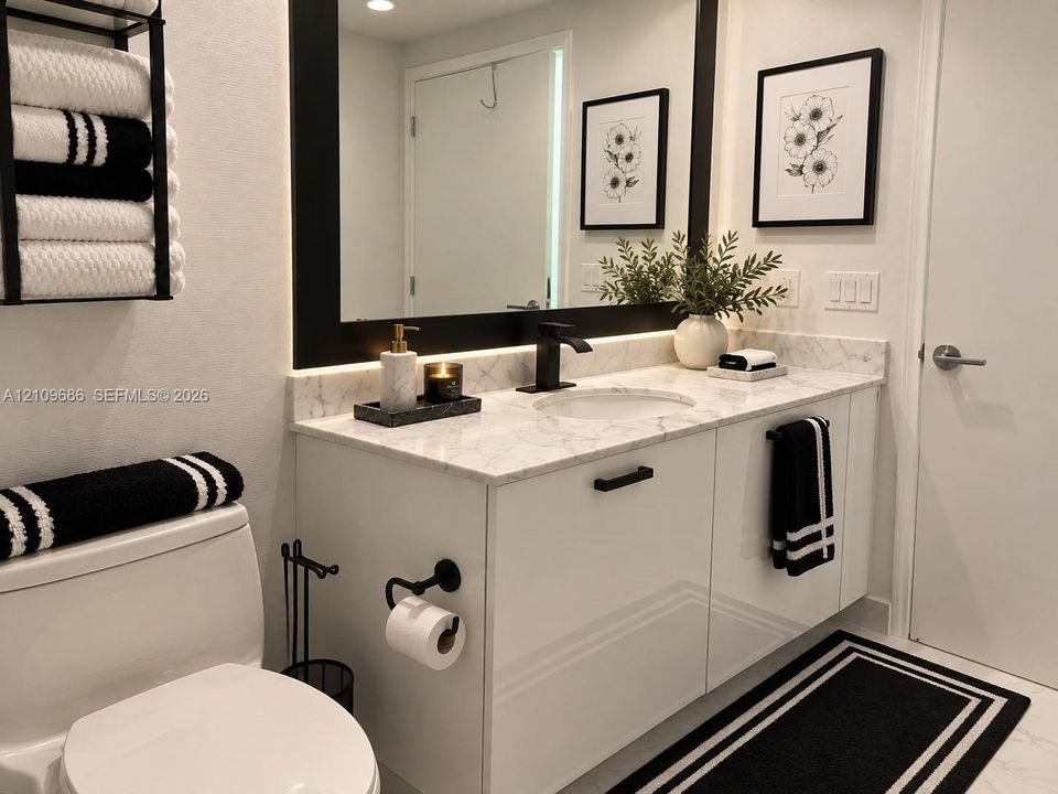 Modern floating vanity with a light-toned stone countertop, integrated sink, matte black faucet, and sleek flat-panel cabinetry