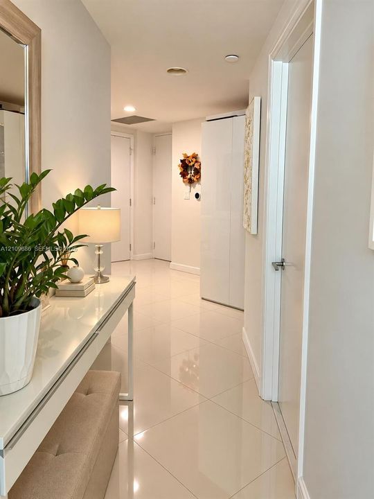 Polished tile flooring, neutral wall finishes, and multiple interior door access points