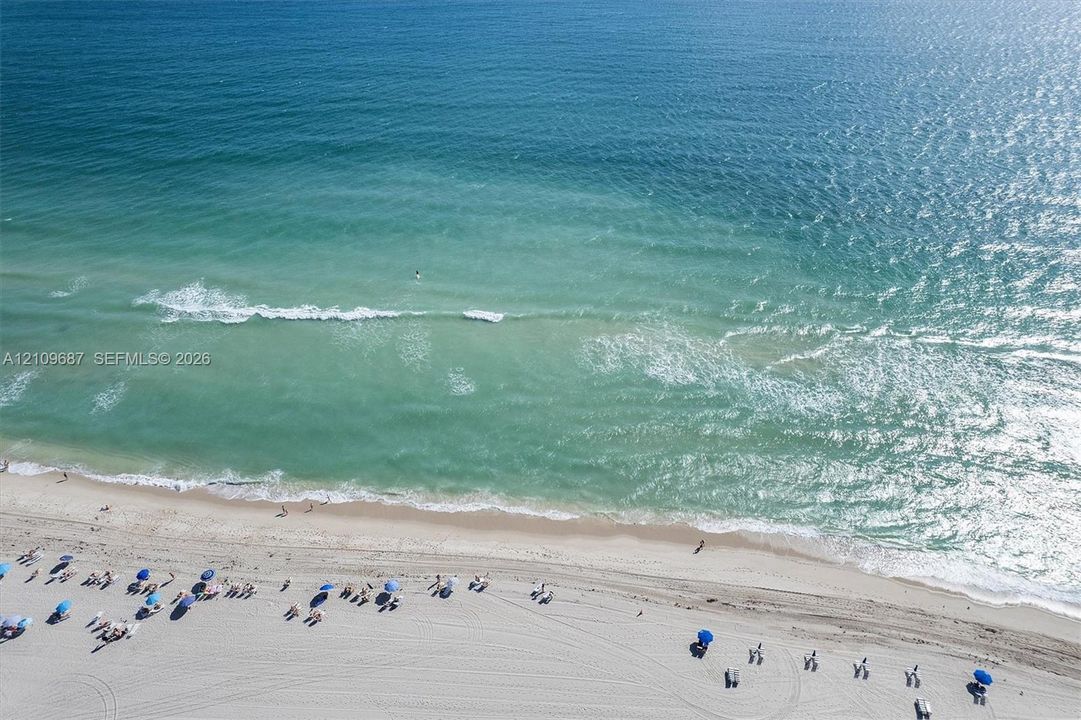Direct beachfront access featuring expansive sandy coastline and open water
