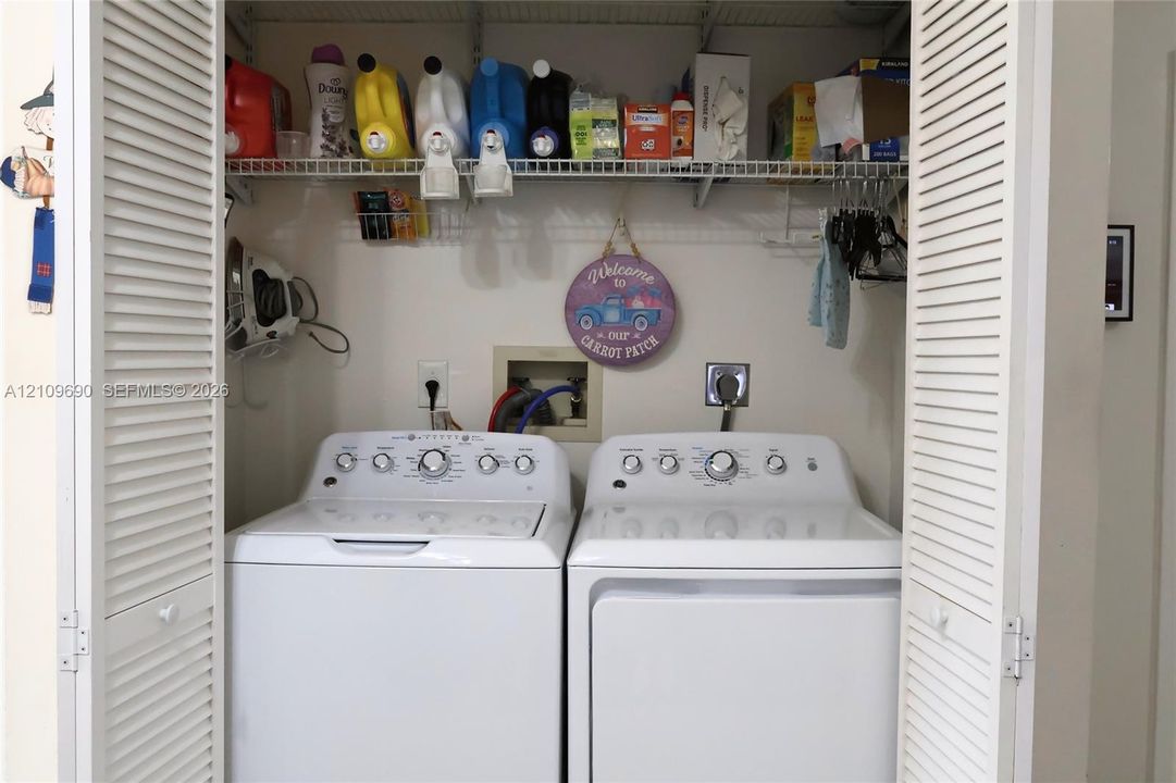 Laundry closet featuring bi-fold louvered doors and wire shelving