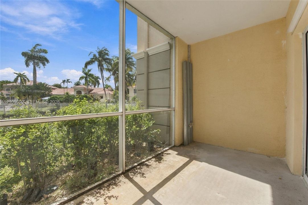 Screened-in lanai featuring concrete flooring and aluminum framing