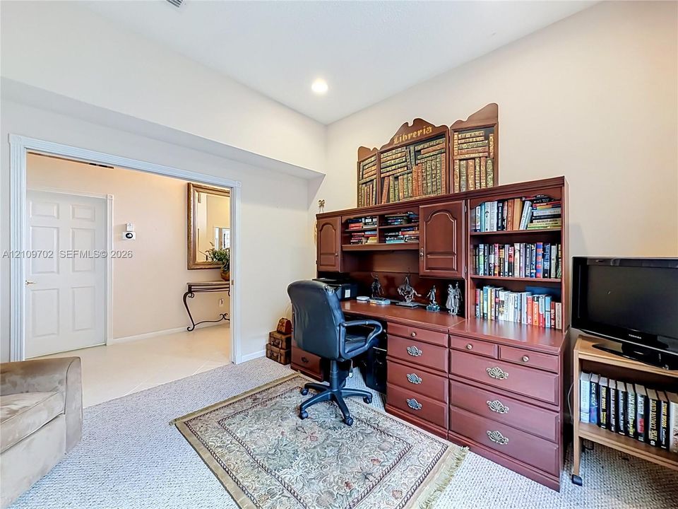 Neutral-toned interior space featuring recessed lighting, a multi-panel door, and wall-to-wall carpeting