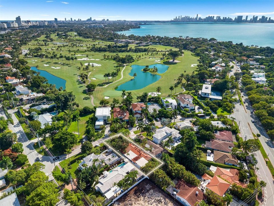 Aerial perspective of property featuring a multi-pitched roofline and mature perimeter landscaping