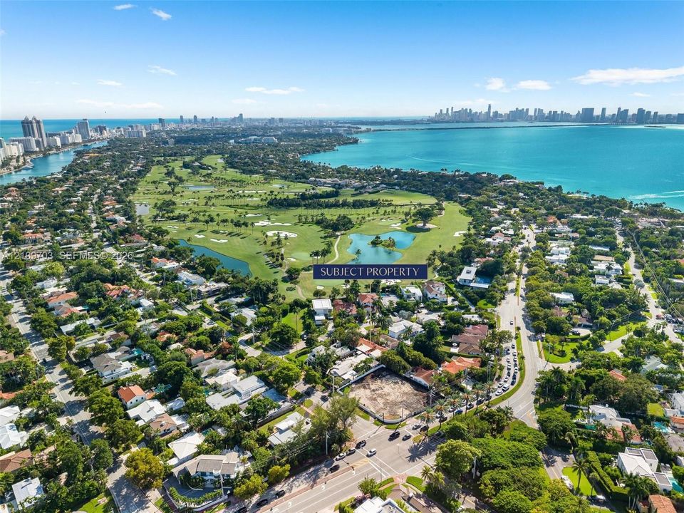 Aerial perspective of a corner lot situated in a coastal residential area, featuring proximity to a golf course and water frontage