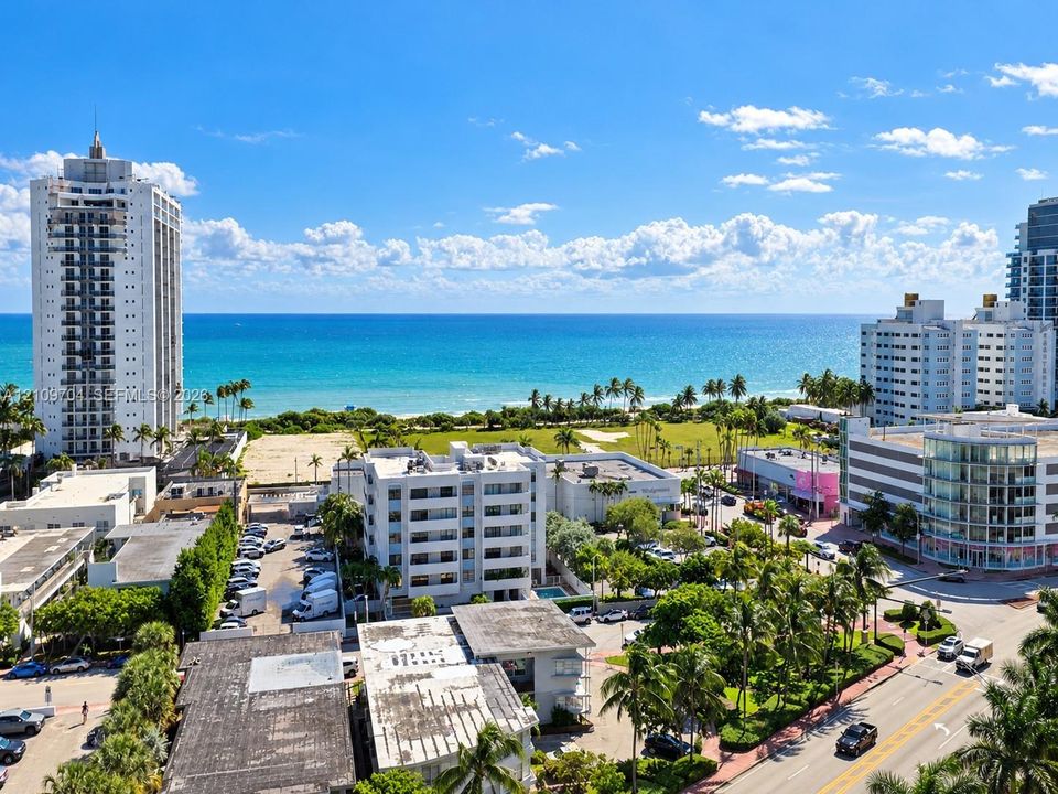 High-rise aerial perspective featuring expansive ocean exposure, proximity to coastal shoreline, and urban landscape with mature palm trees