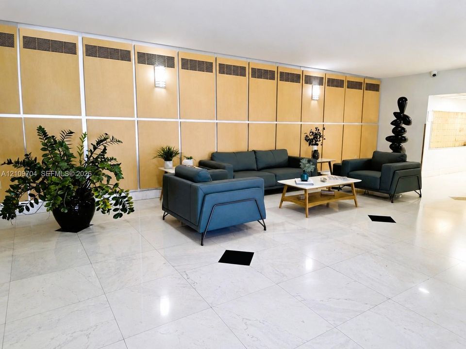 Large-scale wood paneling, polished stone flooring, integrated wall-mounted lighting, and structural square floor accents