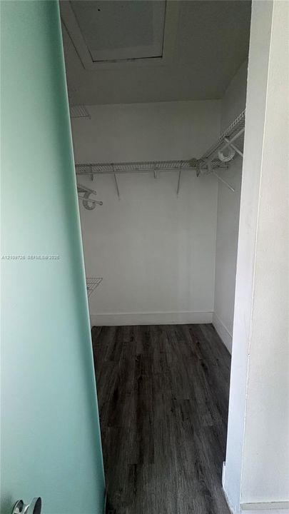 Storage area featuring wood-finish flooring and wire shelving