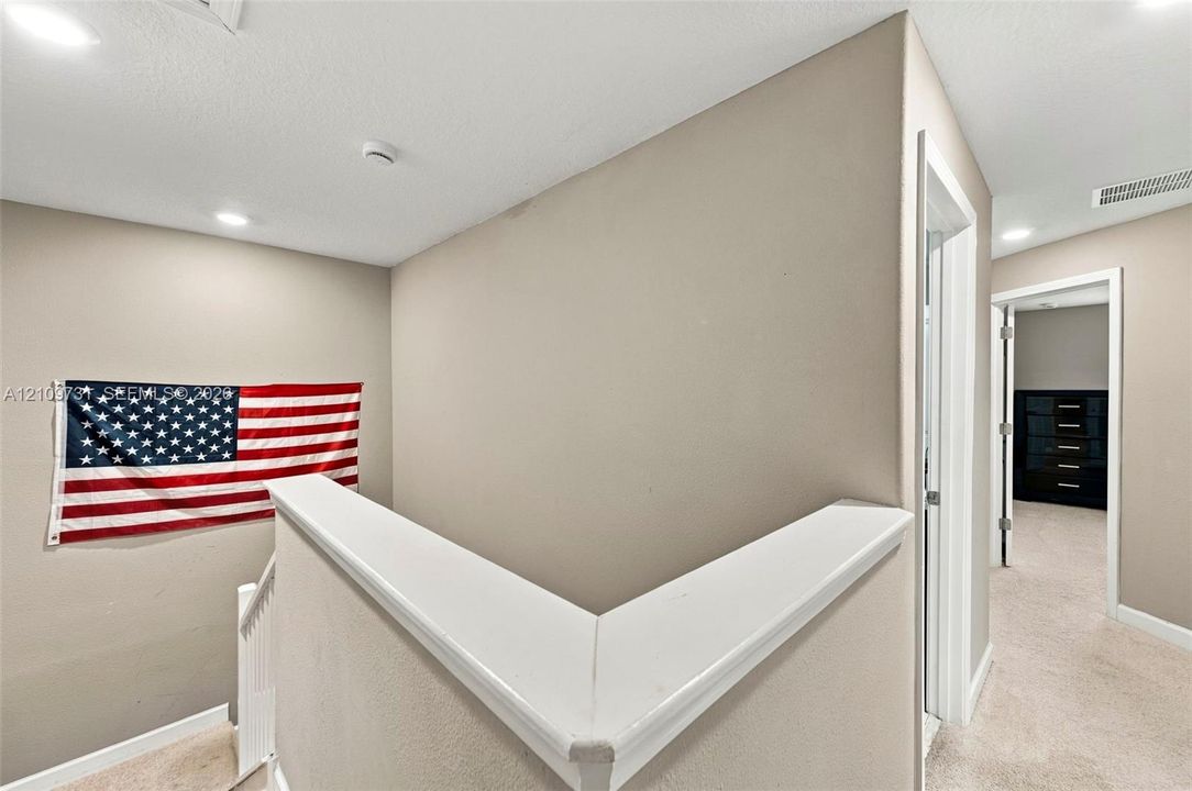 Interior space featuring neutral-toned walls, recessed lighting, and white trim accents