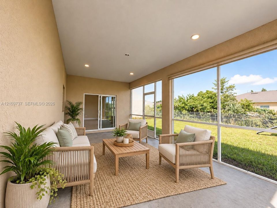 Screened-in porch featuring concrete flooring, recessed lighting, and expansive window panels overlooking the backyard