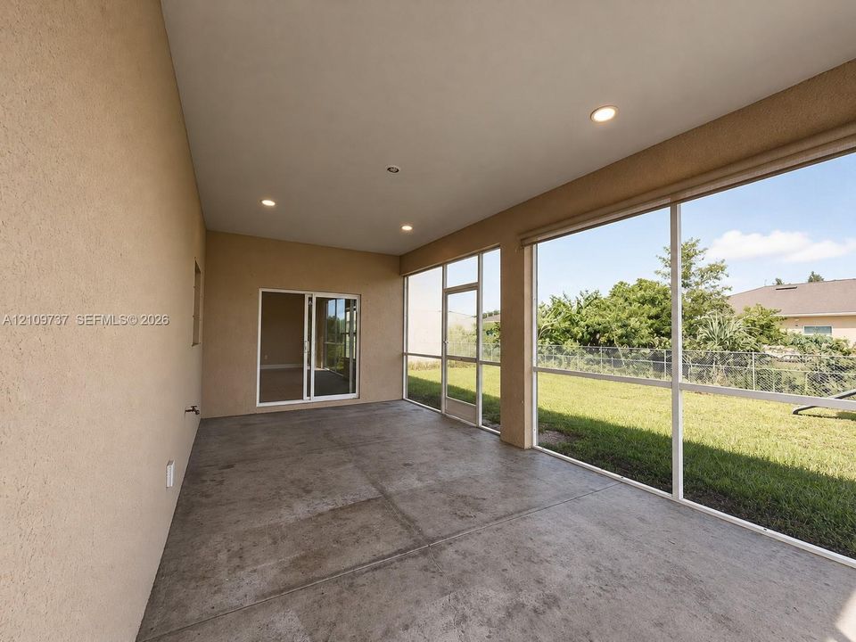 Enclosed patio featuring concrete flooring, recessed lighting, and expansive screened window panels