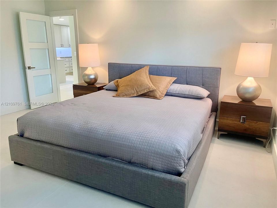 Three-panel interior door with frosted glass inserts and neutral-toned wall finish