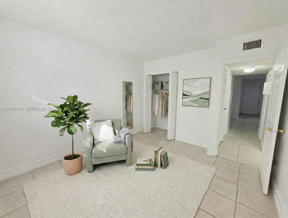 Neutral-toned ceramic tile flooring, closet with bi-fold doors, and built-in full-length mirror
