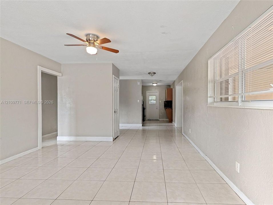 Neutral wall color, ceramic tile flooring, ceiling fan with light kit, and horizontal window blinds