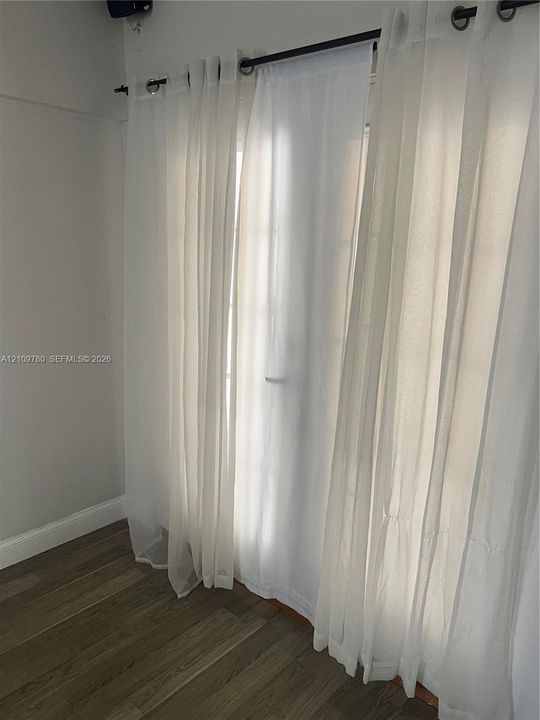 French-door style glass panel entry with wood-finish flooring