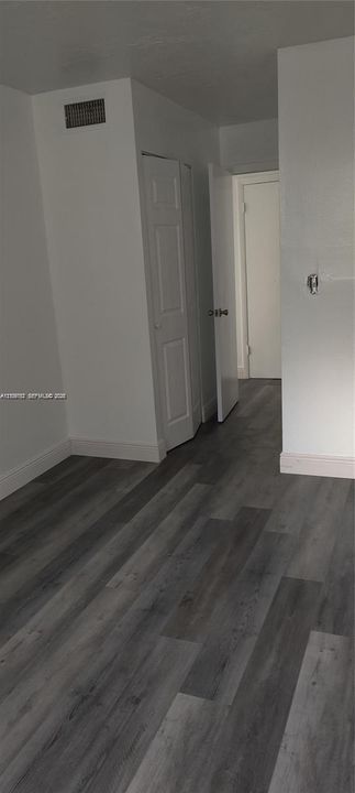 Wood-finish flooring, two-panel interior doors, and neutral wall paint