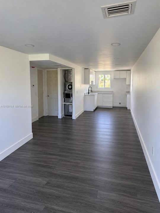 Interior space featuring wood-finish flooring, recessed lighting, and white cabinetry