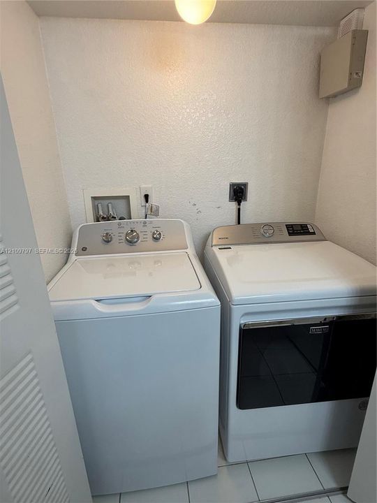 Laundry closet featuring tile flooring, ceiling-mounted light fixture, and dedicated washer and dryer hookups