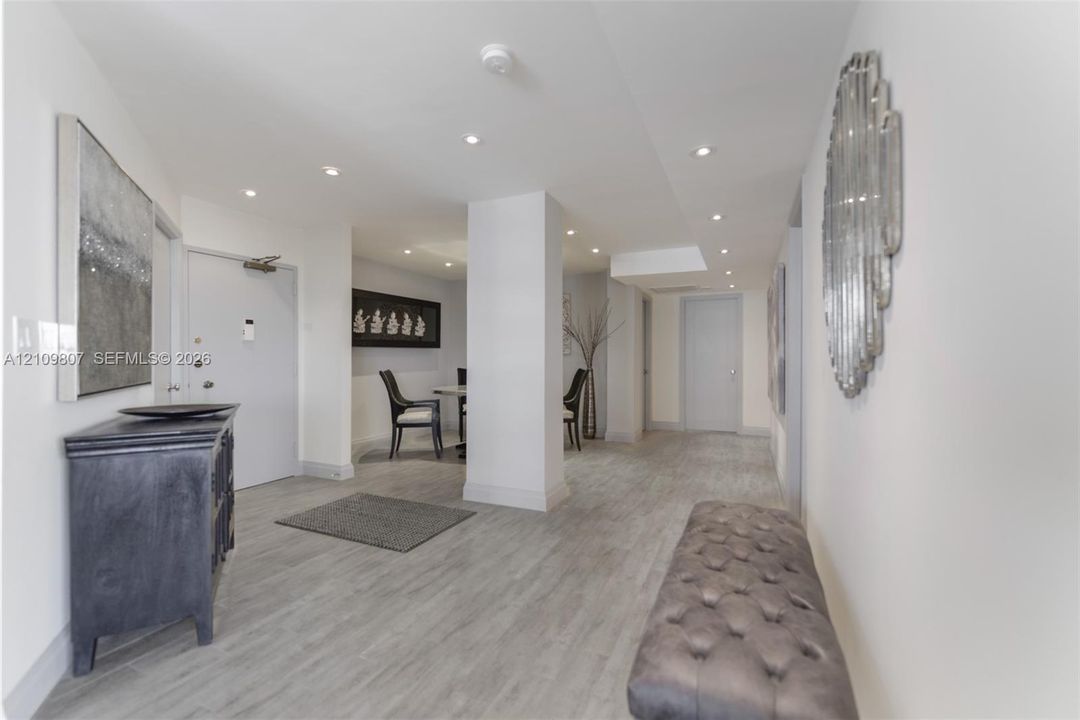 Interior foyer featuring recessed lighting, wood-finish flooring, and crisp white wall finishes