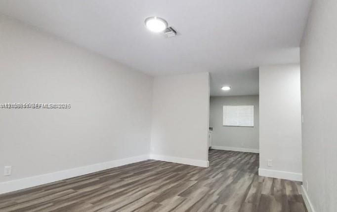 Interior featuring wood-finish flooring, neutral wall paint, and recessed lighting