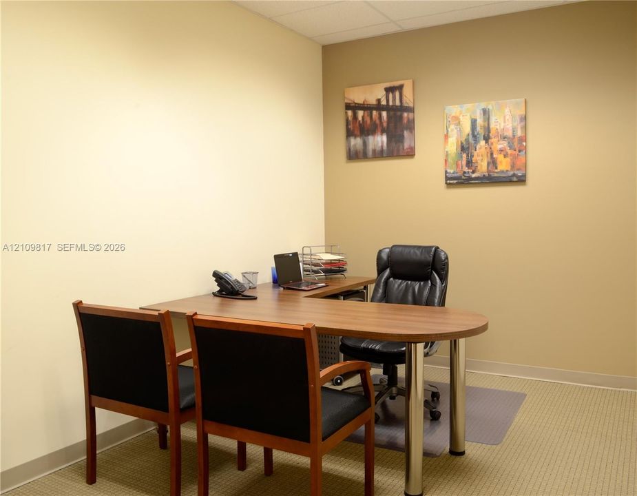 Interior space featuring neutral wall tones and textured carpet flooring