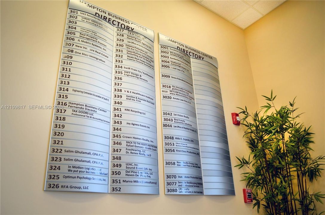 Wall-mounted metallic directory signage featuring extensive modular tenant listings