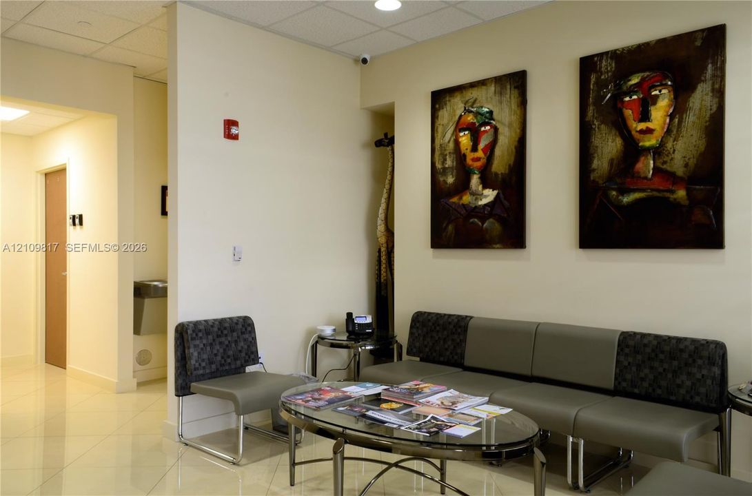 Interior space featuring neutral wall tones, large-format tile flooring, and recessed ceiling lighting