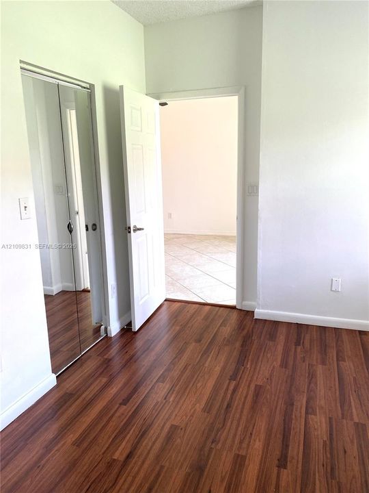 Wood-finish flooring, mirrored closet doors, and interior paneled doors