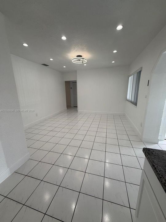 Ceramic tile flooring, recessed lighting, and a modern circular ceiling fixture
