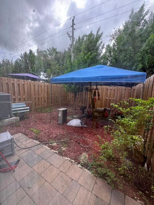 Private backyard featuring a paved patio and wood privacy fencing