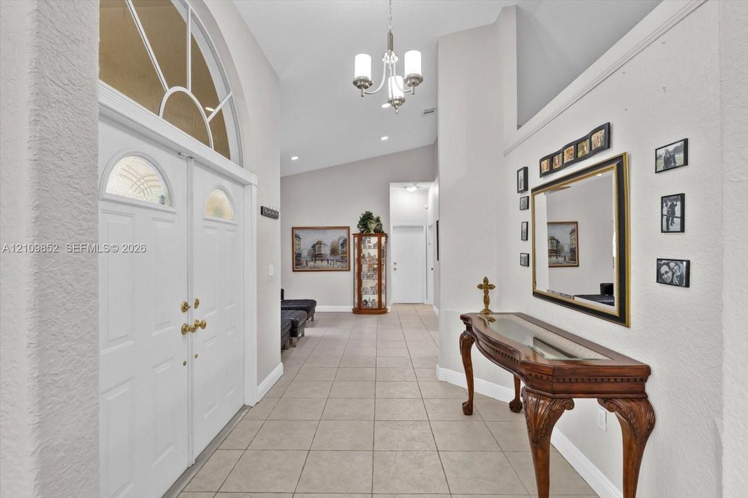 Foyer featuring double entry doors with arched glass inserts *