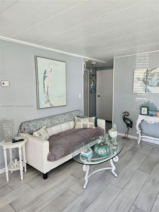 Neutral grey wall paneling and light-toned wood-finish flooring