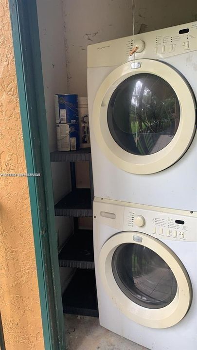 Stacked front-loading washer and dryer unit with integrated control panels