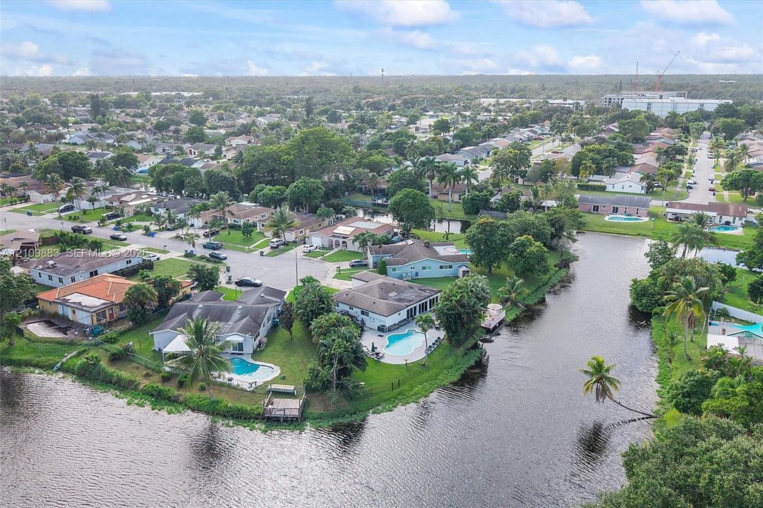Waterfront residential properties featuring in-ground swimming pools, screened-in lanais, and private docks