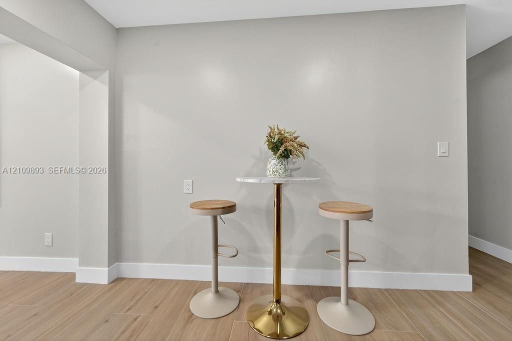 Neutral wall tones paired with wood-finish flooring