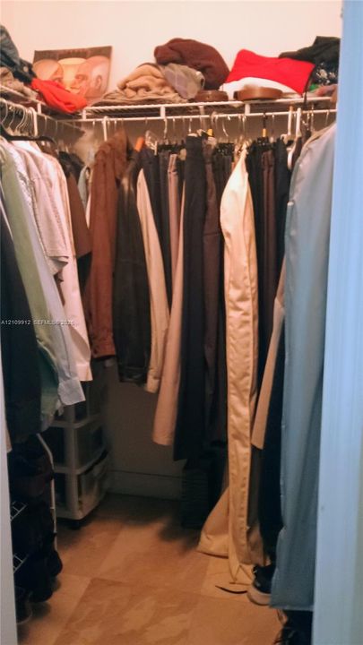 Walk-in closet featuring wire shelving and tile flooring